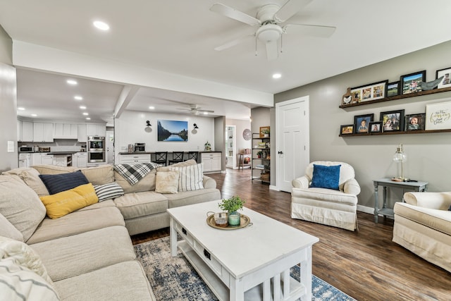 living room with beamed ceiling, dark hardwood / wood-style floors, and ceiling fan