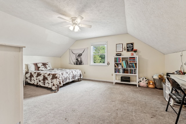 bedroom with lofted ceiling, a textured ceiling, light colored carpet, and ceiling fan