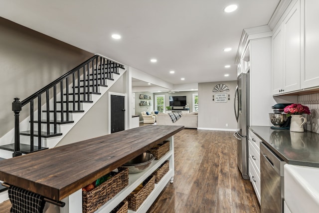 kitchen featuring white cabinets, dark hardwood / wood-style flooring, and appliances with stainless steel finishes