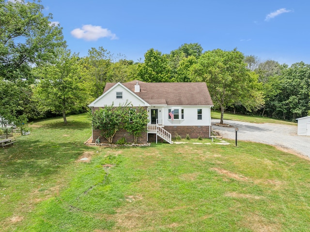 view of front of property with an outbuilding and a front lawn