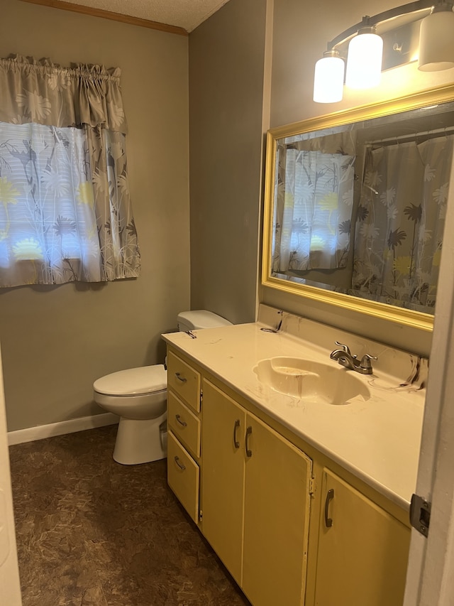 bathroom with vanity, tile patterned flooring, toilet, and a textured ceiling