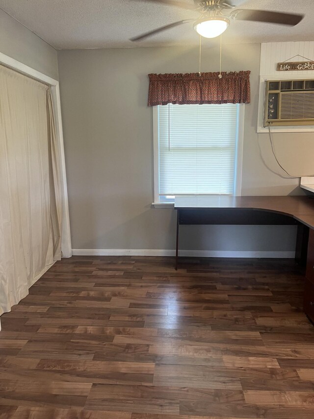 interior space featuring dark hardwood / wood-style floors, a textured ceiling, and ceiling fan