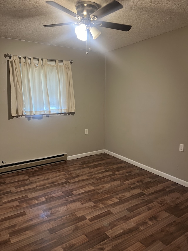 empty room featuring a textured ceiling, dark hardwood / wood-style flooring, baseboard heating, and ceiling fan