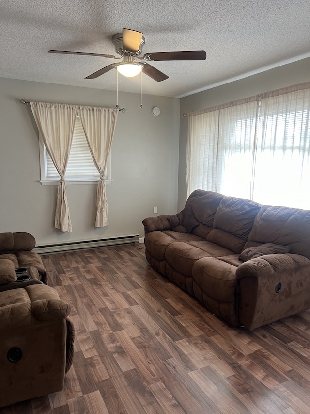 living room featuring ceiling fan, a textured ceiling, hardwood / wood-style flooring, and a baseboard heating unit