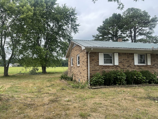 view of side of home featuring a yard