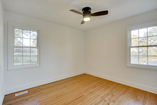 unfurnished room with light hardwood / wood-style flooring, a wealth of natural light, and ceiling fan