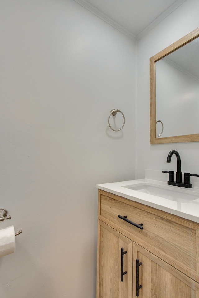 bathroom with ornamental molding and vanity