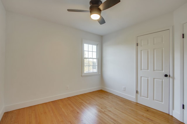 empty room with ceiling fan and light hardwood / wood-style flooring