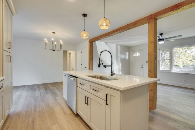 kitchen with an island with sink, decorative light fixtures, sink, and dishwasher