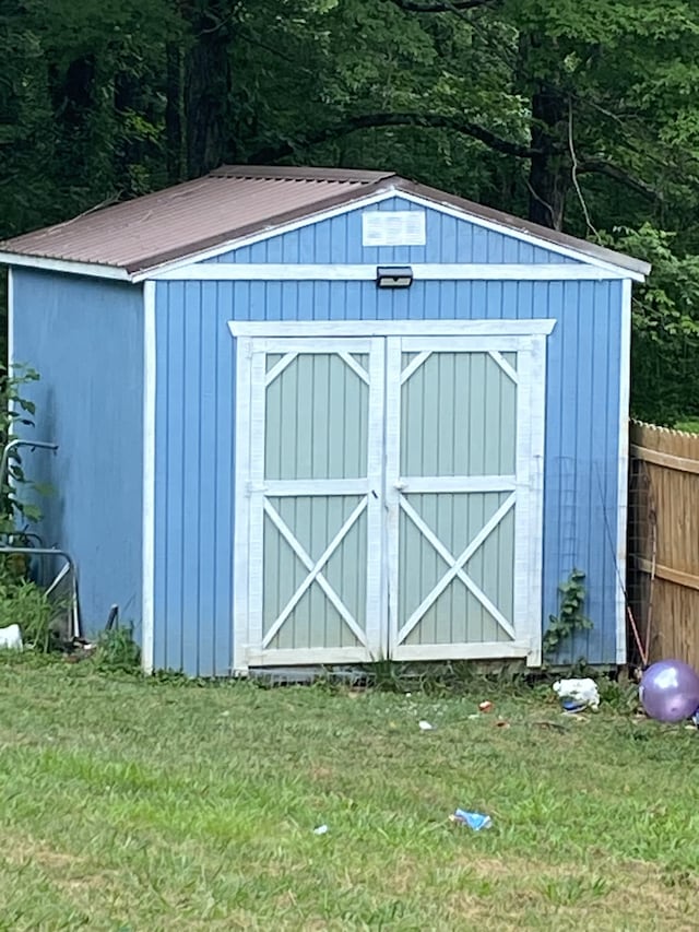 view of outdoor structure featuring a lawn