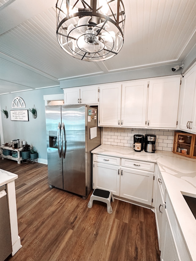 kitchen with dark hardwood / wood-style flooring, white cabinetry, tasteful backsplash, and stainless steel appliances