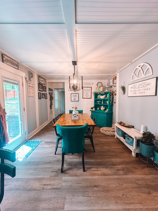 dining area with a chandelier and dark hardwood / wood-style flooring