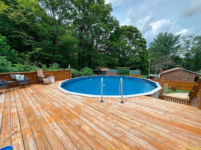 view of pool with a wooden deck