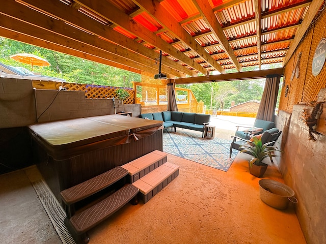 view of patio with a hot tub and an outdoor hangout area