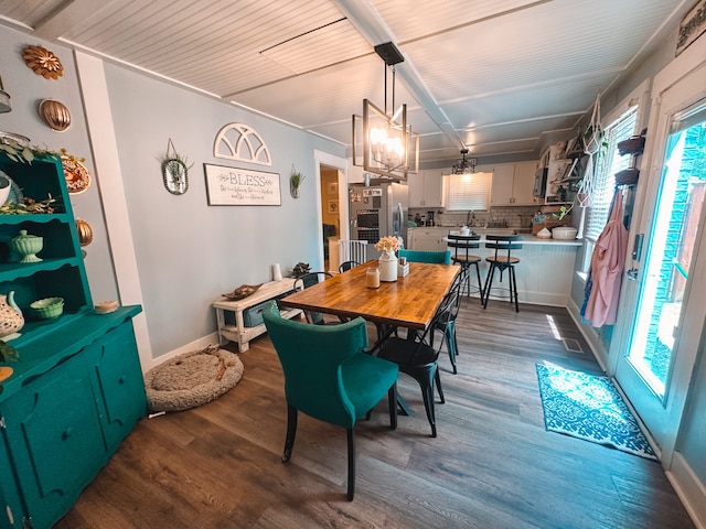 dining room featuring plenty of natural light and dark hardwood / wood-style flooring