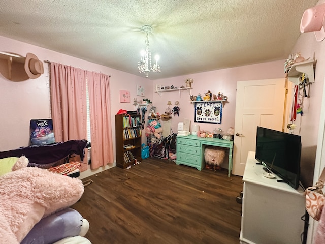 interior space featuring a chandelier, a textured ceiling, and dark hardwood / wood-style flooring