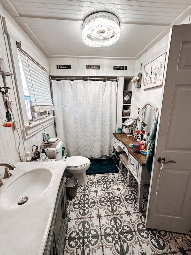 bathroom with vanity, tile patterned flooring, and toilet