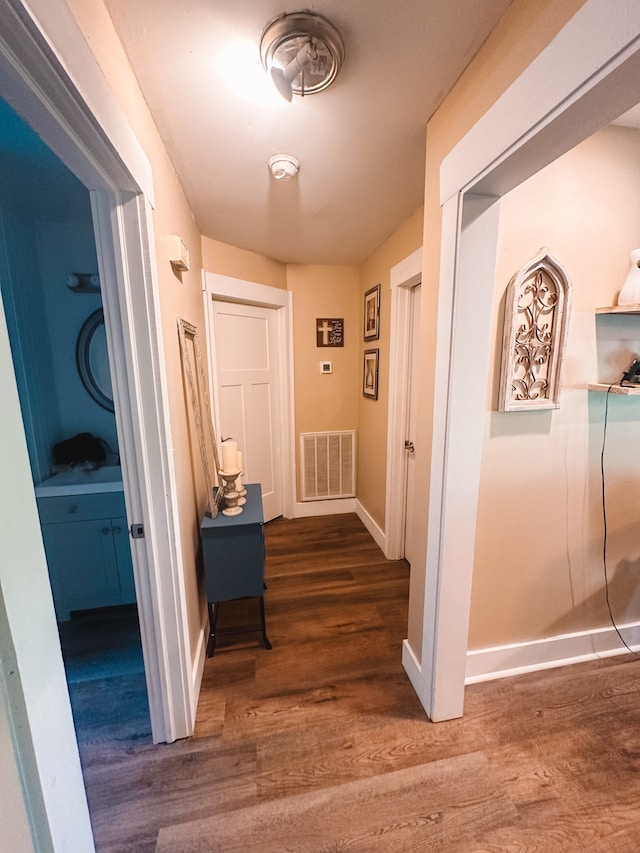 hallway with hardwood / wood-style floors