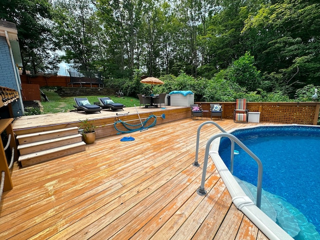 view of pool featuring a wooden deck