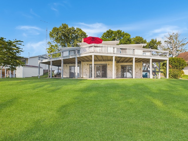 rear view of property with a yard and a deck