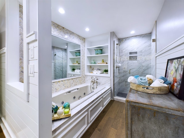 bathroom featuring built in features, shower with separate bathtub, and hardwood / wood-style flooring