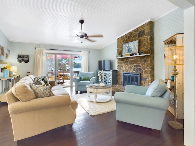 living room with a stone fireplace, lofted ceiling, hardwood / wood-style floors, and ceiling fan