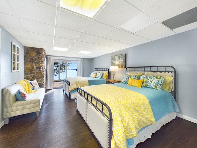 bedroom featuring hardwood / wood-style floors and a paneled ceiling