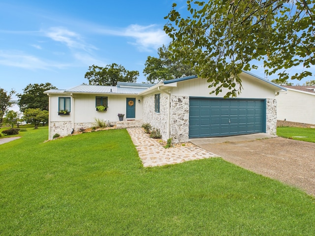 ranch-style house featuring a garage and a front lawn