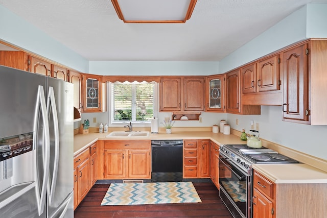 kitchen featuring sink, black appliances, exhaust hood, and dark wood-type flooring