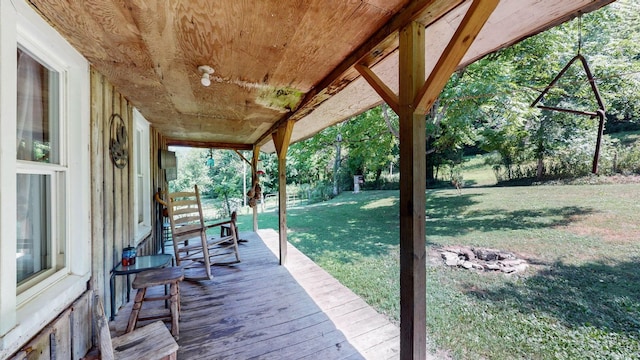 wooden deck featuring a yard