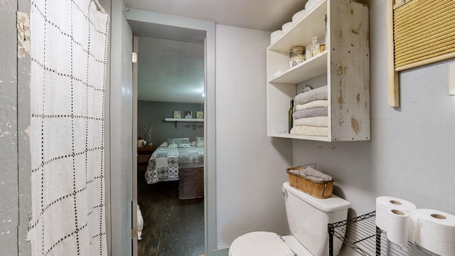 bathroom featuring toilet and wood-type flooring