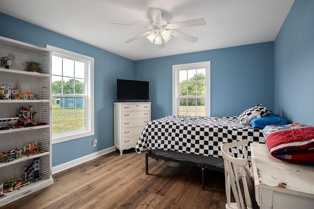 bedroom with ceiling fan and hardwood / wood-style flooring