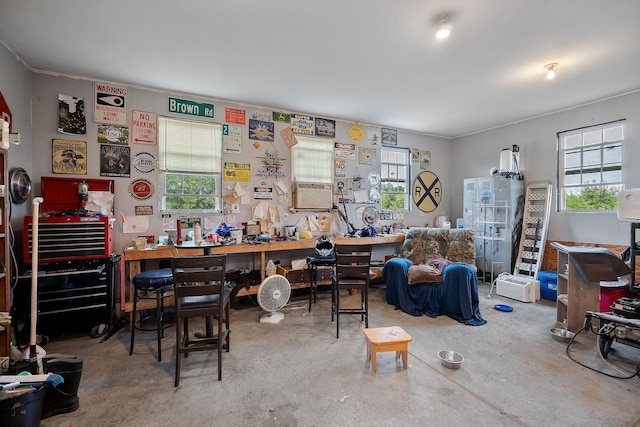 office space with cooling unit, a workshop area, and concrete floors