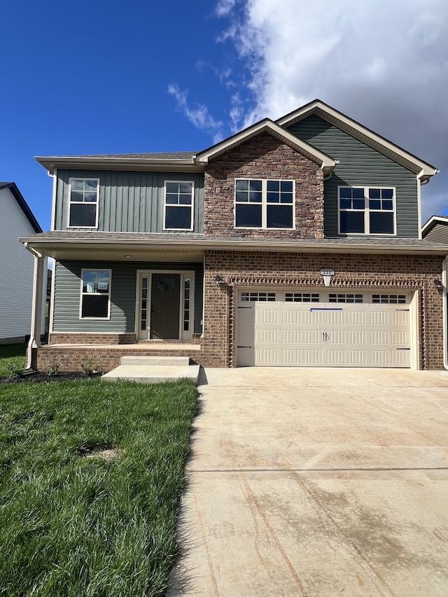 view of front of property featuring covered porch, a front yard, and a garage