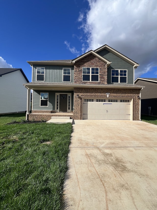 view of front of home with covered porch, a front yard, and a garage