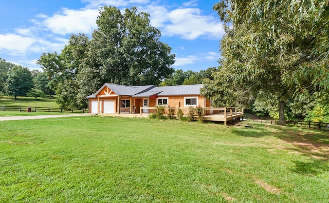 exterior space with a deck, a garage, and a lawn