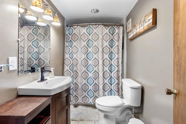 bathroom with toilet, vanity, tile patterned flooring, and a shower with curtain