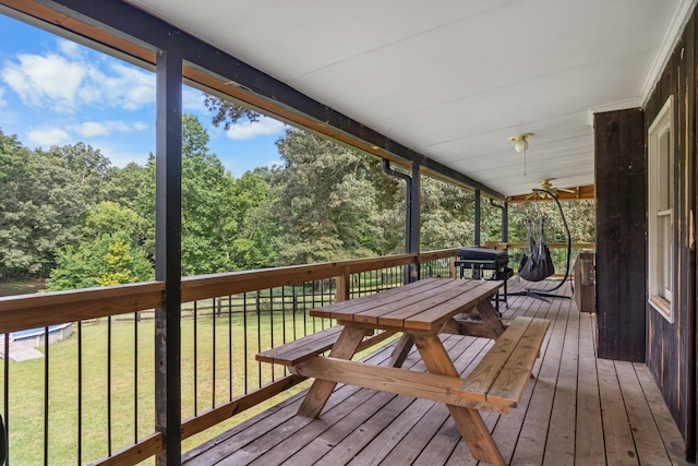 wooden terrace featuring a yard