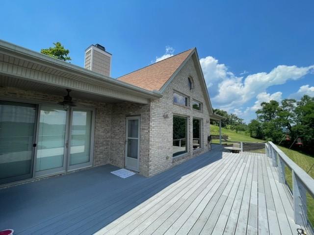 wooden deck featuring ceiling fan