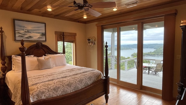 bedroom featuring a water view, access to outside, wooden ceiling, ceiling fan, and light hardwood / wood-style floors