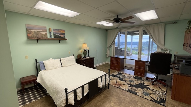 bedroom with a paneled ceiling and ceiling fan