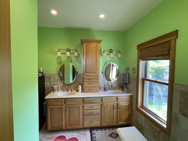 bathroom featuring vanity, tile patterned flooring, and tile walls