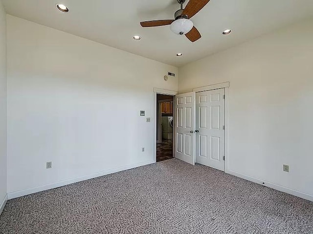 carpeted spare room featuring recessed lighting, baseboards, and ceiling fan