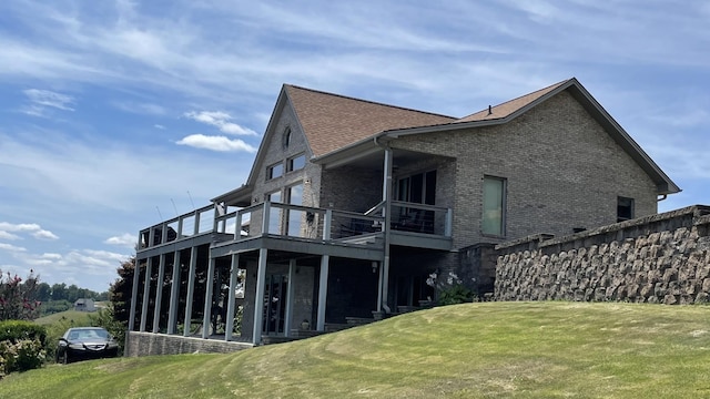 61 Brim Ln, Hilham, TN 38568 - back of house featuring a yard, brick siding, and a shingled roof