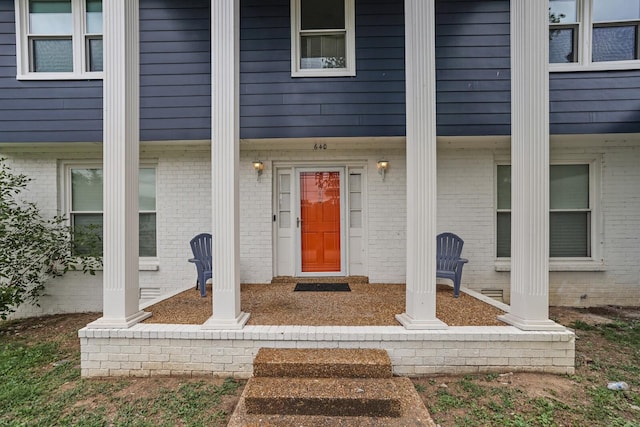 property entrance featuring brick siding