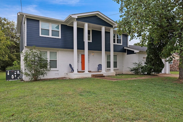 view of front facade with covered porch, brick siding, crawl space, and a front lawn