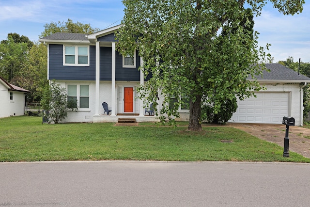 view of front of property featuring a front lawn and a garage