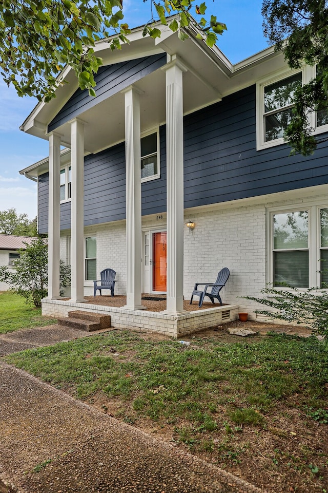 view of exterior entry with covered porch