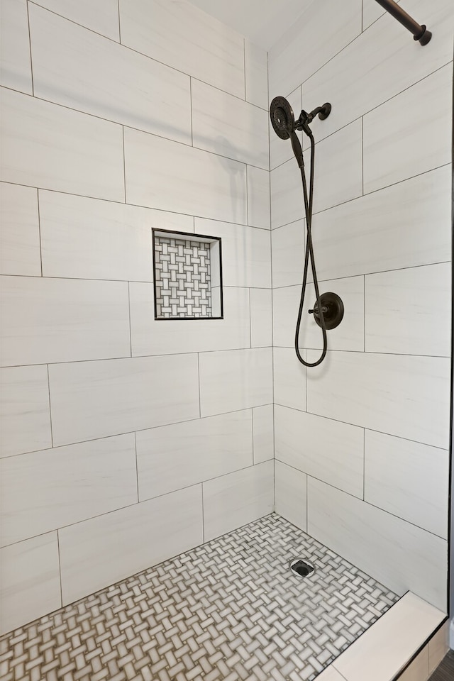 bathroom with tiled shower