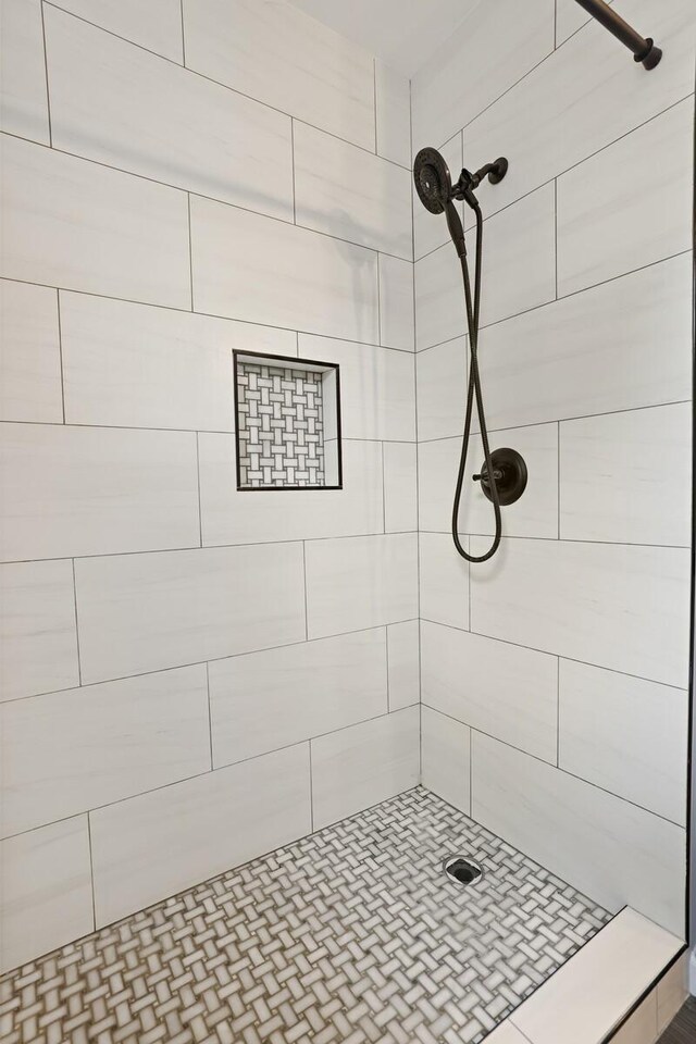 bathroom with tiled shower